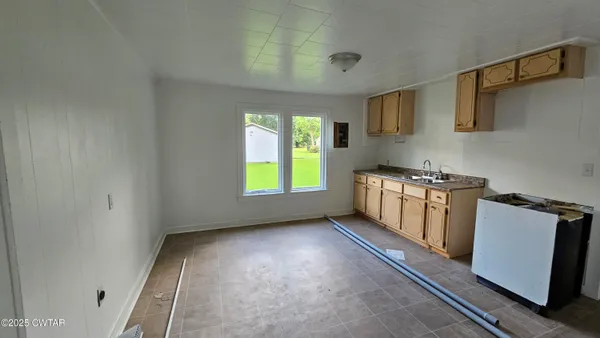 a kitchen with a sink a stove and cabinets