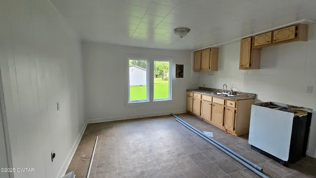 a kitchen with a sink a stove and cabinets