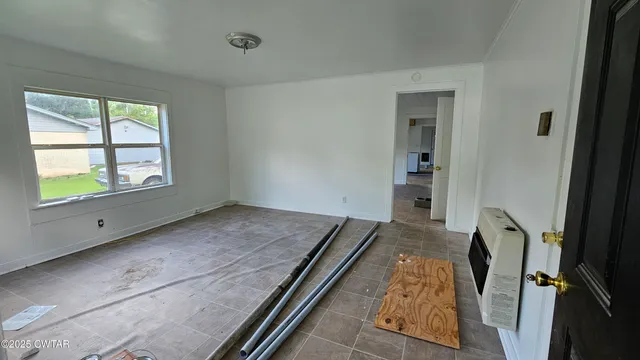 a view of an empty room and window