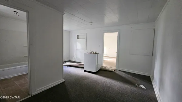 an empty room with windows and closet