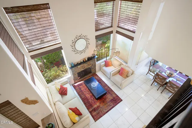 a dining room with furniture a chandelier and wooden floor