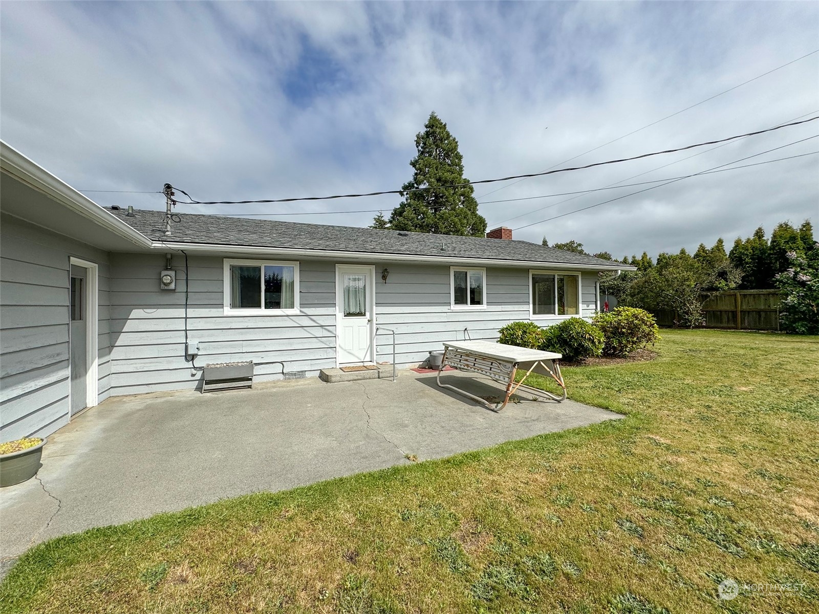 8944 Old Olympic Highway Sequim, WA 98382 - Photo 16 of 40 a view of a house with backyard and a tree