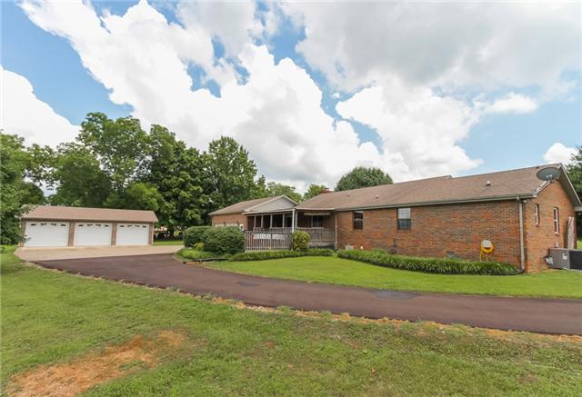 4024 New Chapel Road Springfield, TN 37172 - Photo 3 of 20 Open concreted area around the detached three car garage with paved black top drive way!