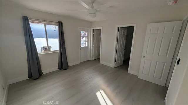 an empty room with windows and closet