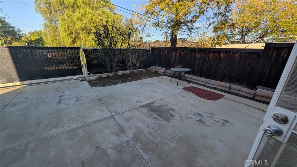905 West Sumner Avenue, Unit B Lake Elsinore, CA 92530 - Photo 14 of 15 a view of a backyard with wooden fence