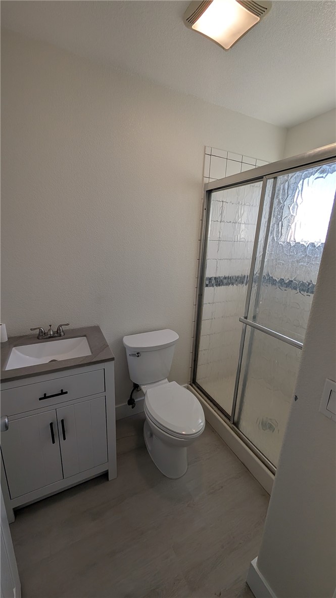 905 West Sumner Avenue, Unit B Lake Elsinore, CA 92530 - Photo 5 of 15 a bathroom with a granite countertop toilet and a sink