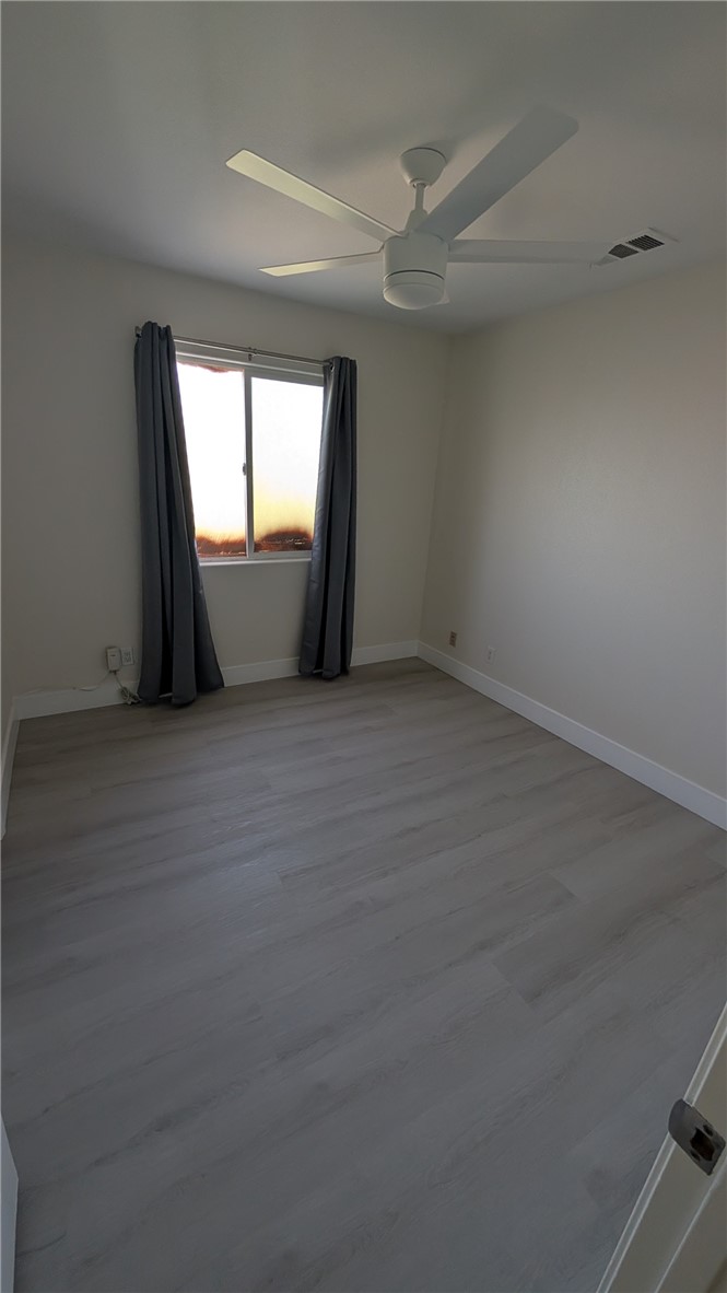 905 West Sumner Avenue, Unit B Lake Elsinore, CA 92530 - Photo 6 of 15 wooden floor and window in an empty room