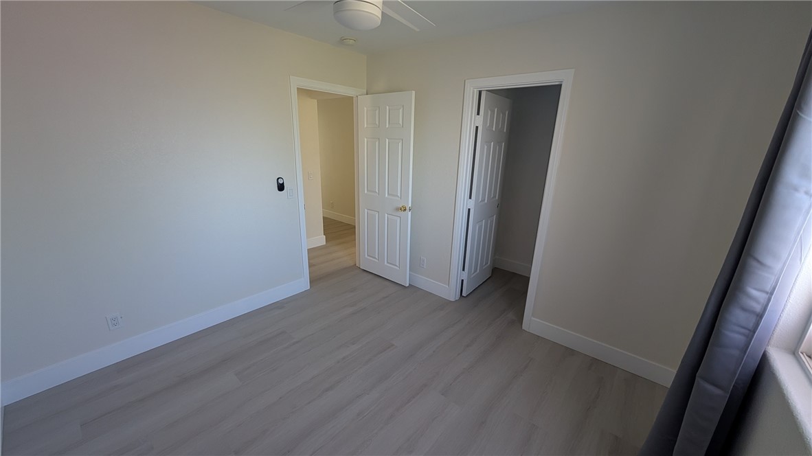905 West Sumner Avenue, Unit B Lake Elsinore, CA 92530 - Photo 7 of 15 an empty room with wooden floor and closet