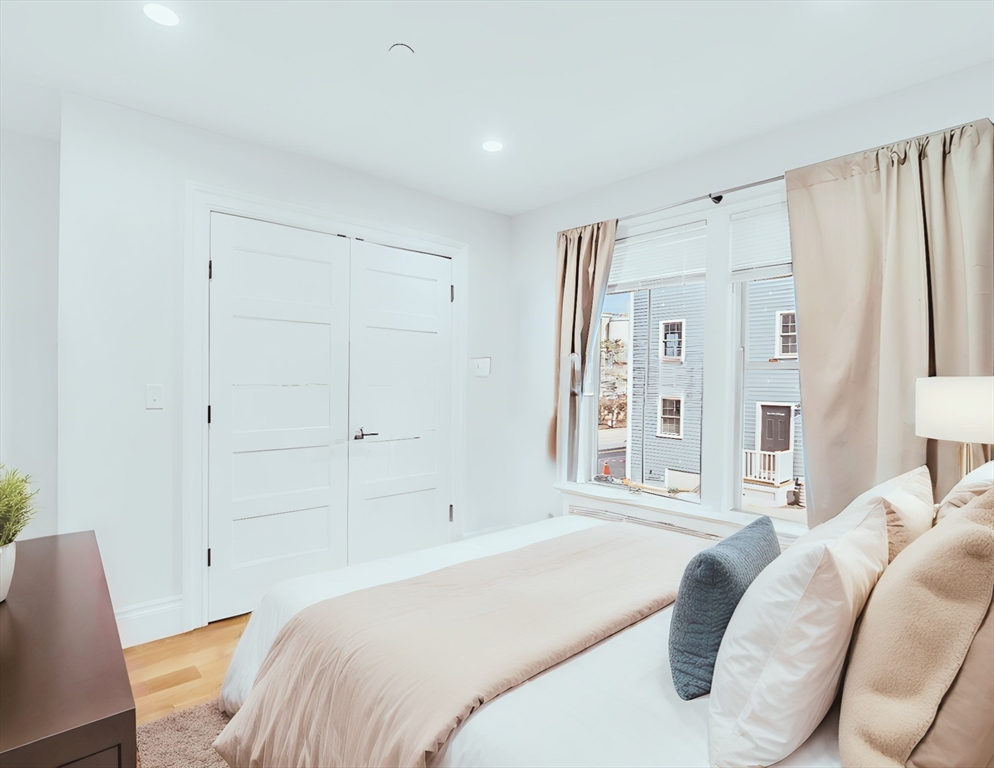 56 Belmont Street, Unit 1 Boston, MA 02129 - Photo 15 of 27 a bedroom with a bed and a window