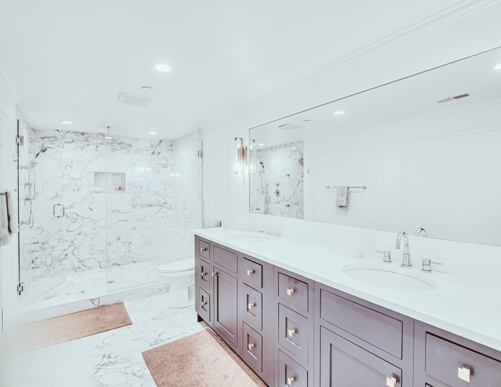 56 Belmont Street, Unit 1 Boston, MA 02129 - Photo 24 of 27 a bath room with a sink tub vanity and a shower