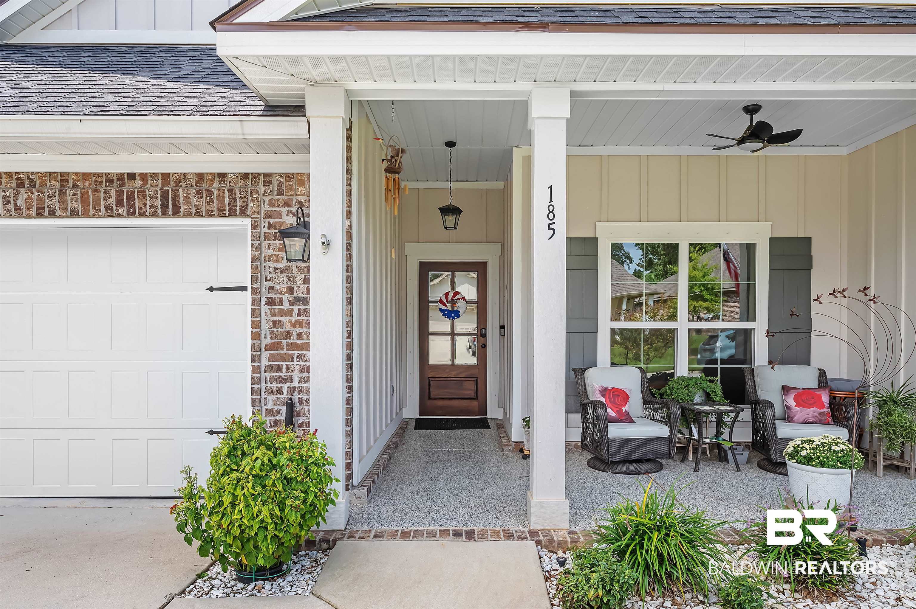 185 Mark Twain Loop Foley, AL 36535 - Photo 4 of 54 Entrance to property featuring ceiling fan, a porch, and a garage