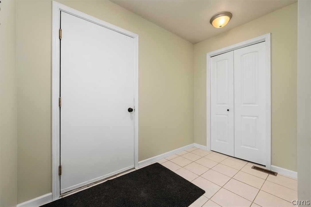 1322 Sawmill Road Sangerfield, NY 13480 - Photo 36 of 50 Tiled flooring and neutral walls define this functional home entrance.