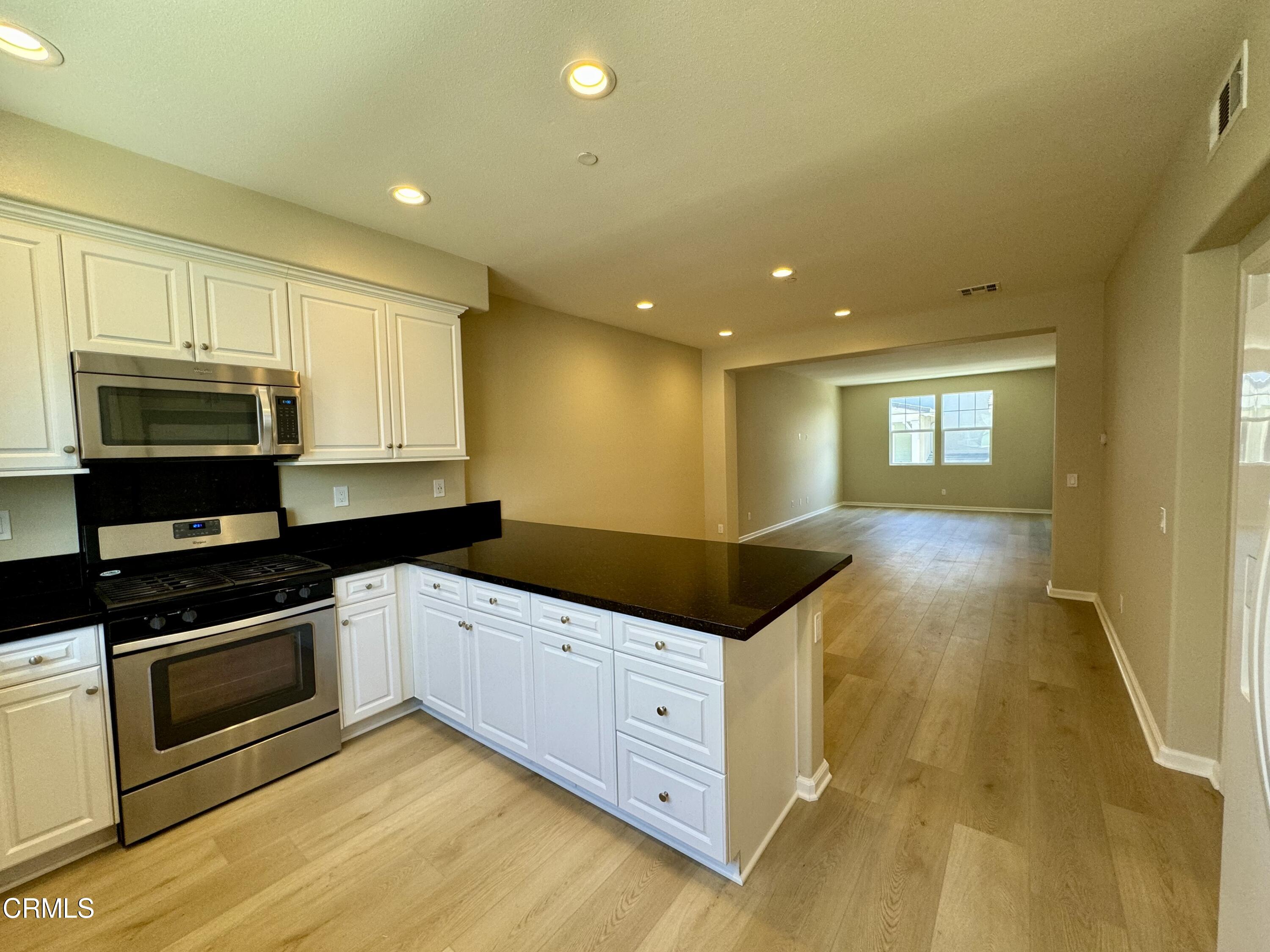 3667 Islander Walk Oxnard, CA 93035 - Photo 14 of 33 a kitchen with granite countertop a sink and stainless steel appliances