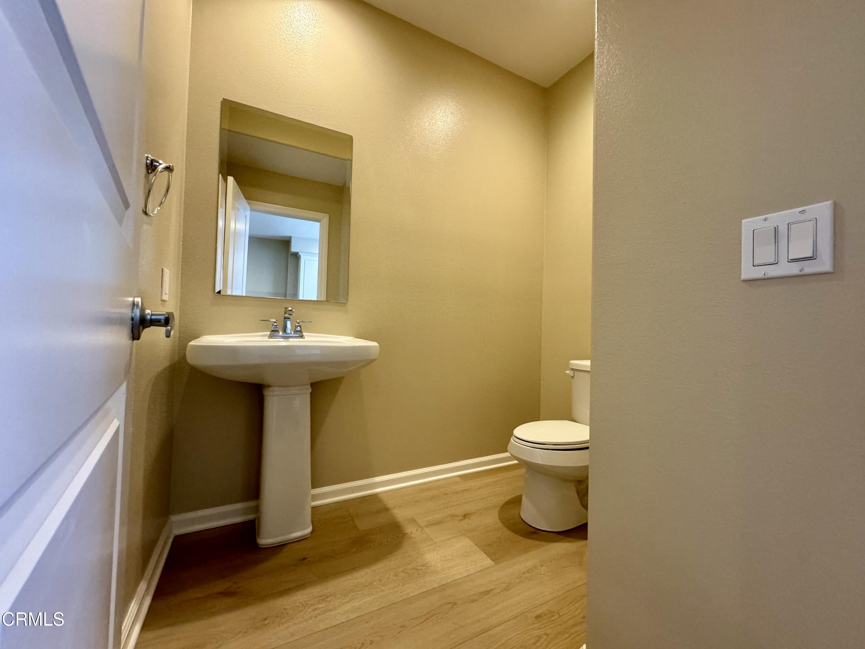 3667 Islander Walk Oxnard, CA 93035 - Photo 17 of 33 a bathroom with a sink toilet and a mirror