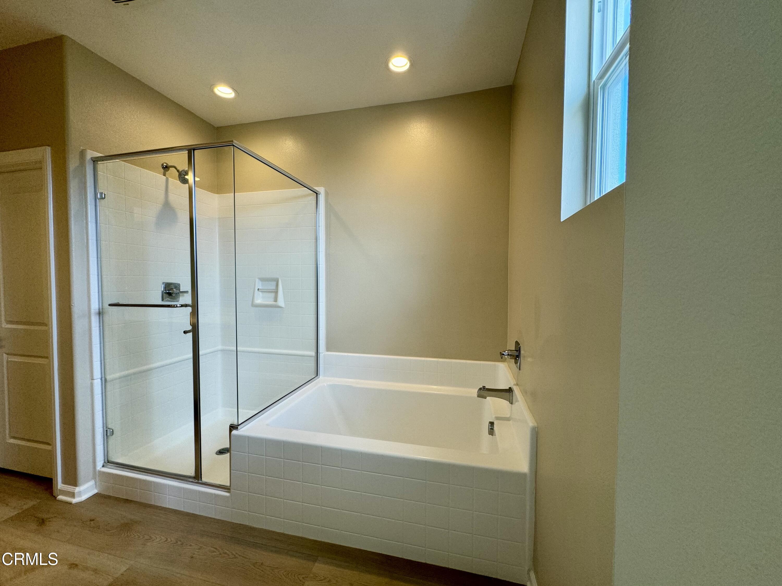 3667 Islander Walk Oxnard, CA 93035 - Photo 20 of 33 a bathroom with a bathtub and a shower