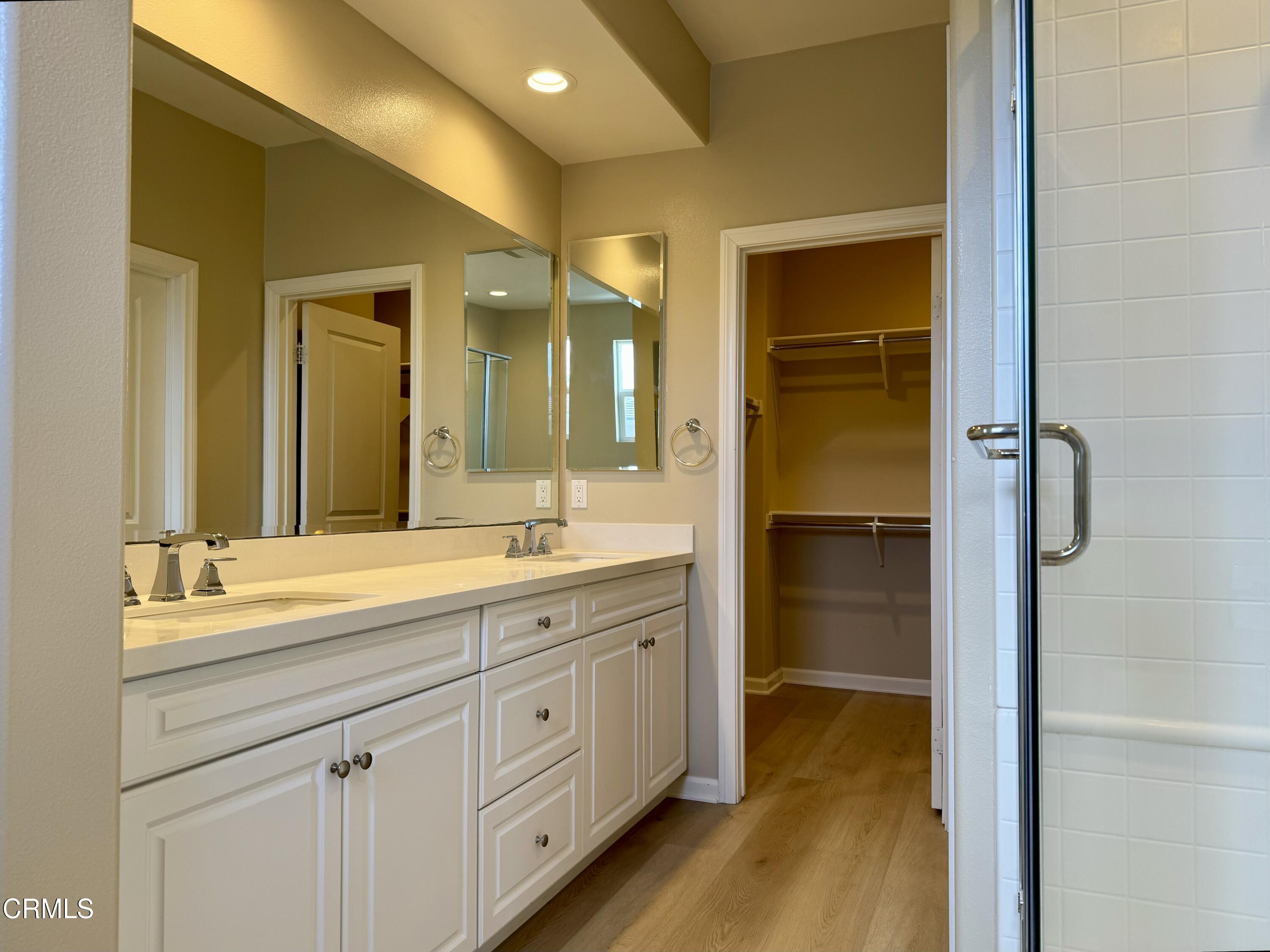 3667 Islander Walk Oxnard, CA 93035 - Photo 22 of 33 a spacious bathroom with a shower a sink and a mirror