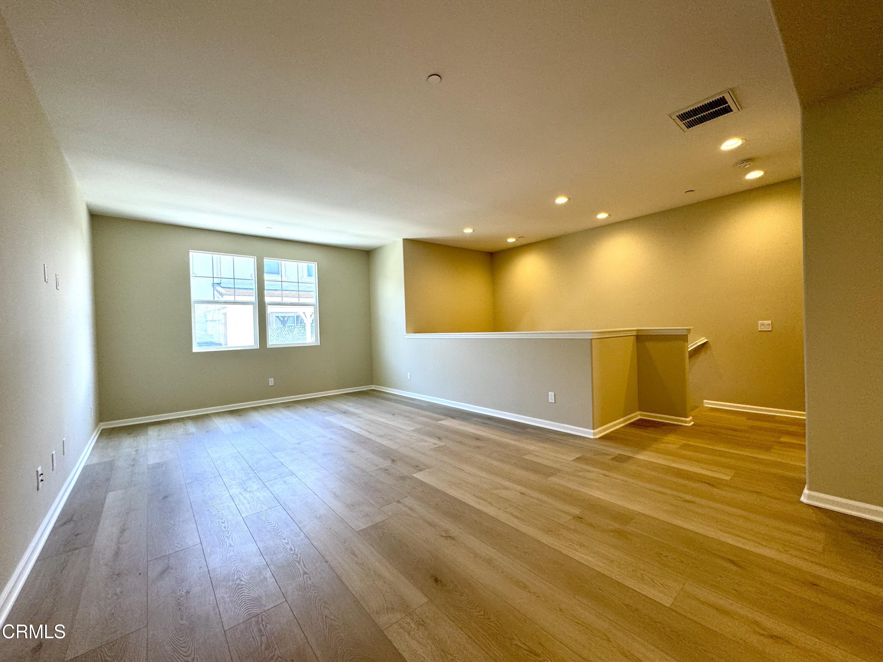 3667 Islander Walk Oxnard, CA 93035 - Photo 7 of 33 a view of an empty room with wooden floor and a window