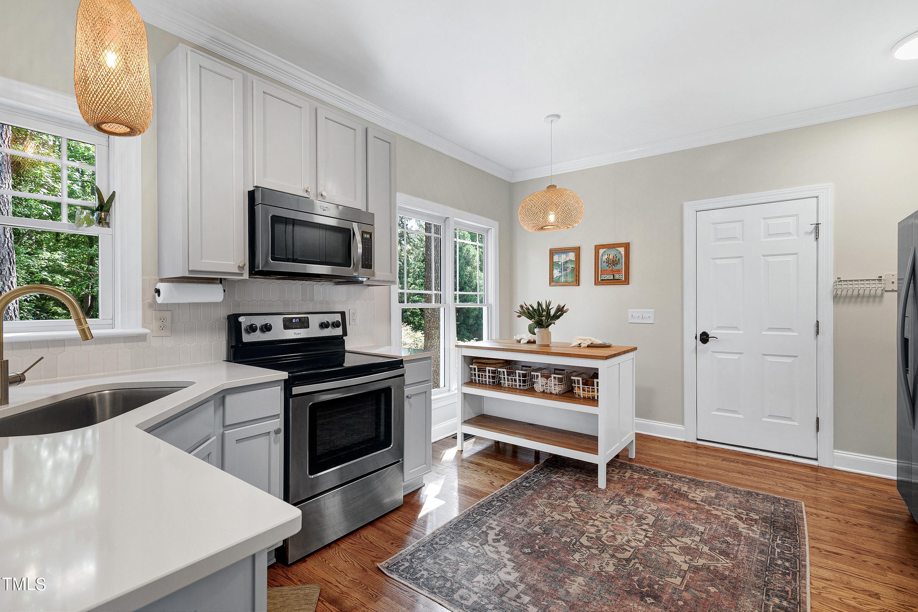 110 Rushing Wind Way Apex, NC 27502 - Photo 11 of 27 Updated kitchen with white quartz, stainless appliances