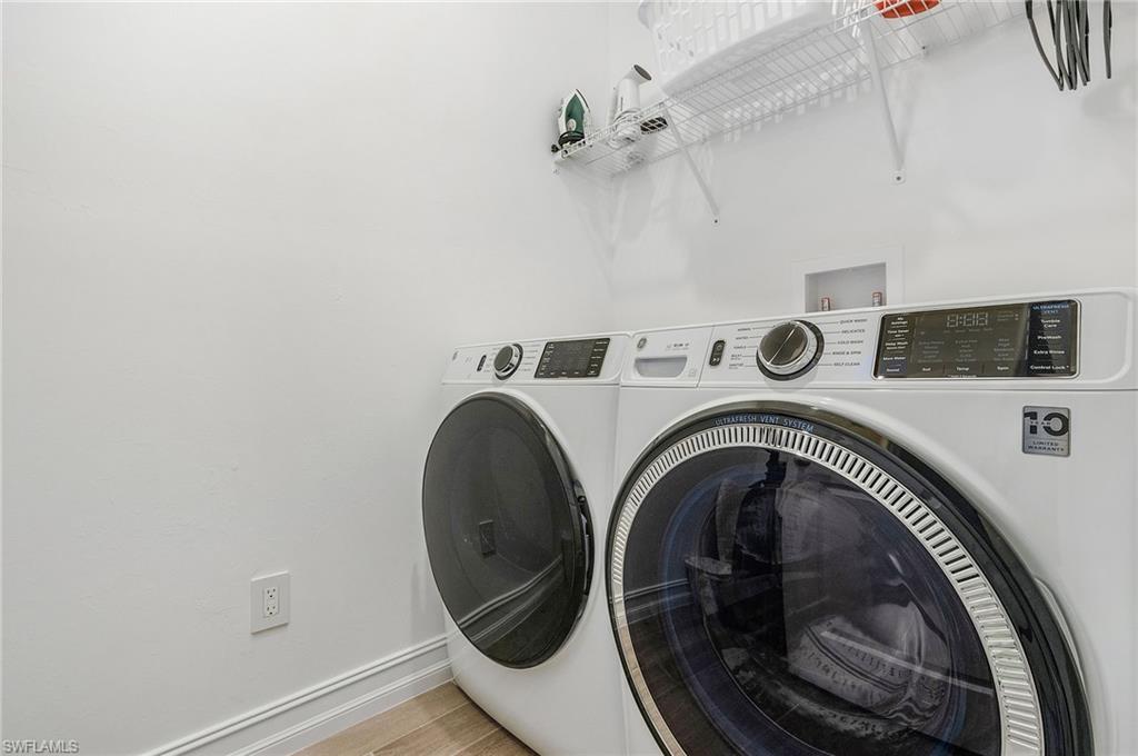 7596 Morgan Way Naples, FL 34119 - Photo 24 of 35 a utility room with dryer and washer