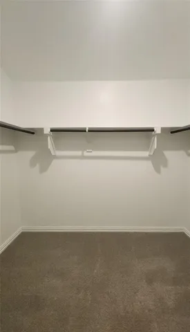 a view of an empty room and a window