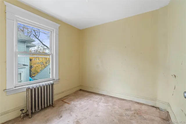 a view of a big room with windows and entryway