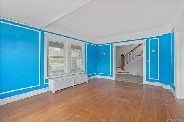 a view of empty room with wooden floor and cabinet