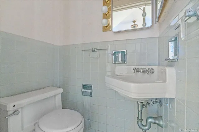 a white toilet sitting next to a bathroom sink