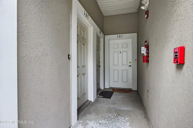 a view of a hallway with closet and wooden floor