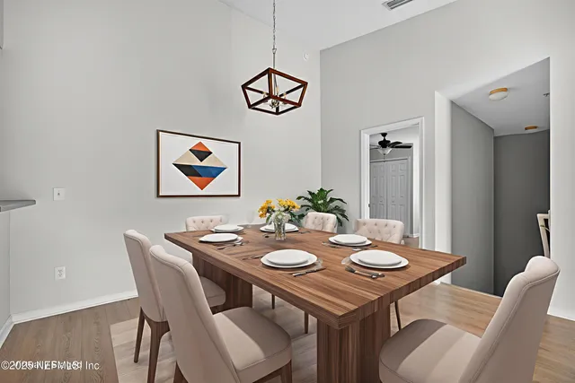 a view of a dining room with furniture and wooden floor