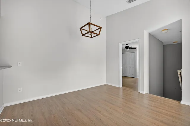 a view of a room with wooden floor