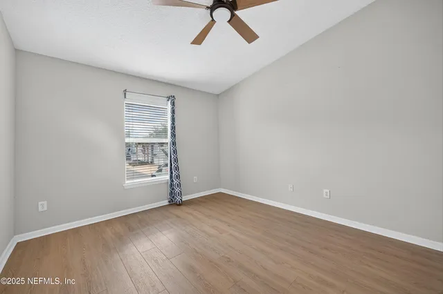 wooden floor in an empty room with a window