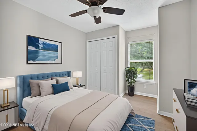 a bedroom with bed and wooden floor