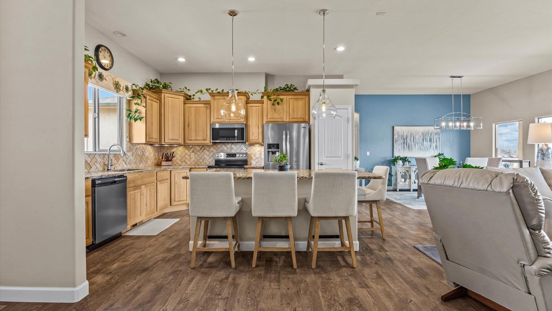 686 Beech Avenue Fruita, CO 81521 - Photo 14 of 33 a dining room with stainless steel appliances kitchen island granite countertop a dining table chairs and view living room