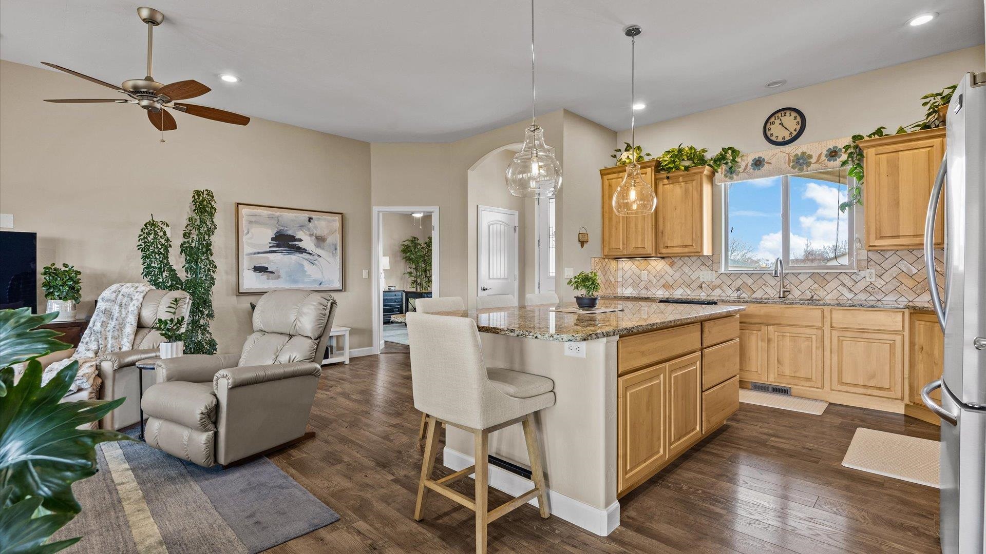686 Beech Avenue Fruita, CO 81521 - Photo 15 of 33 a living room with furniture a fireplace and a chandelier