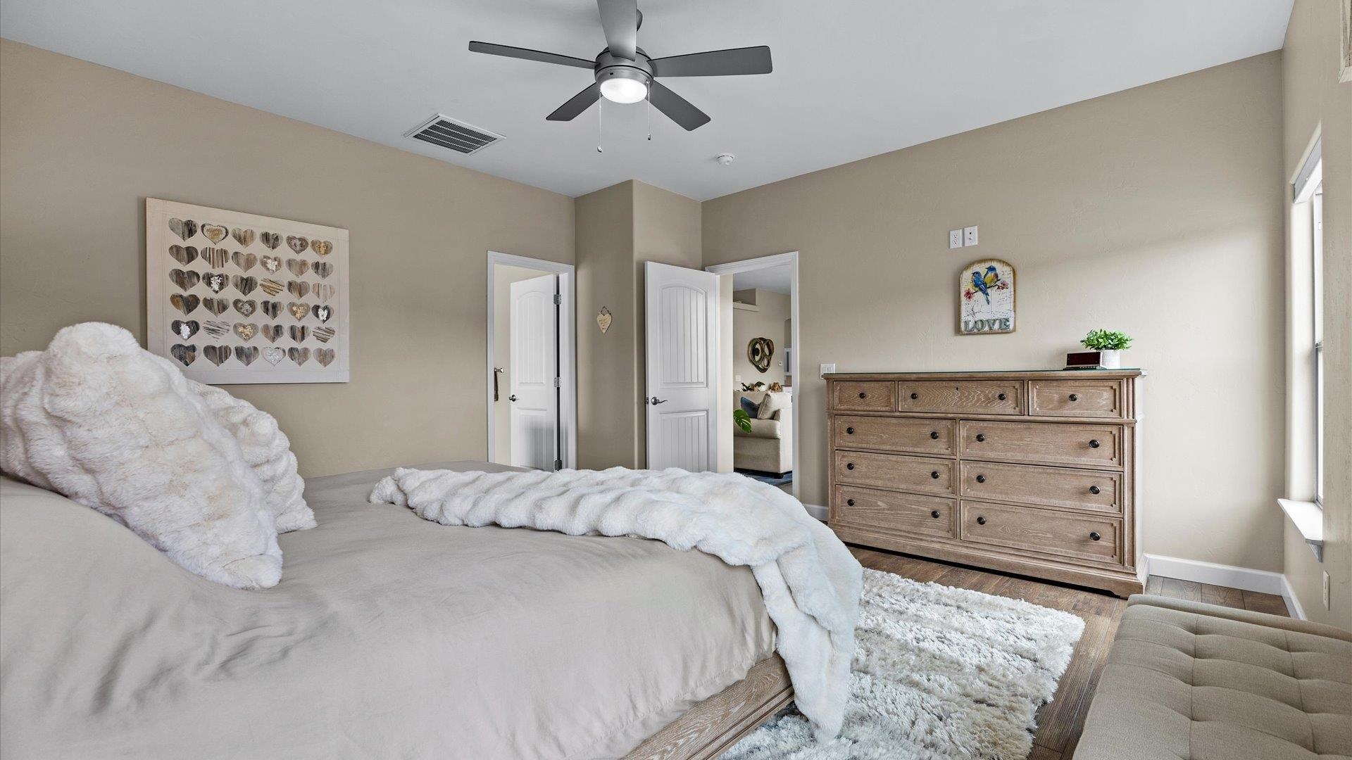686 Beech Avenue Fruita, CO 81521 - Photo 19 of 33 a bedroom with a bed a dresser and painting on the wall