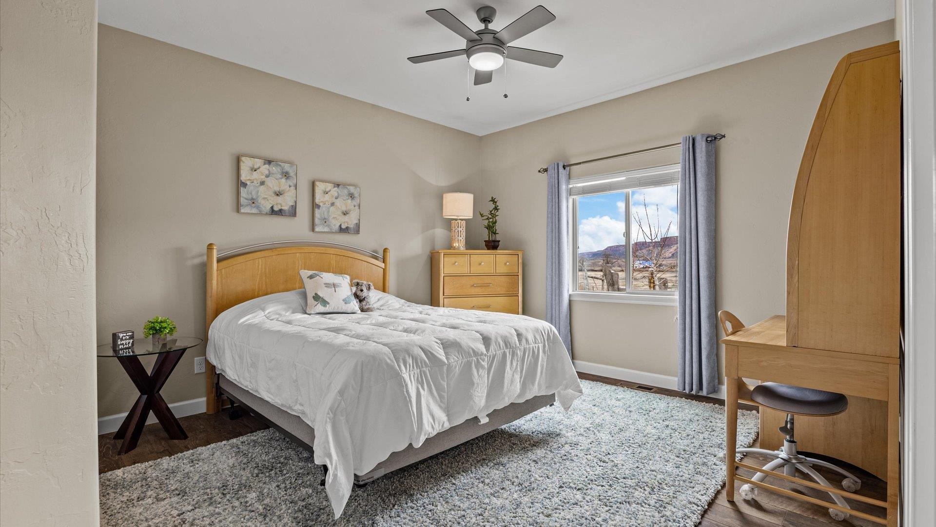 686 Beech Avenue Fruita, CO 81521 - Photo 22 of 33 a bedroom with a bed and wooden floor