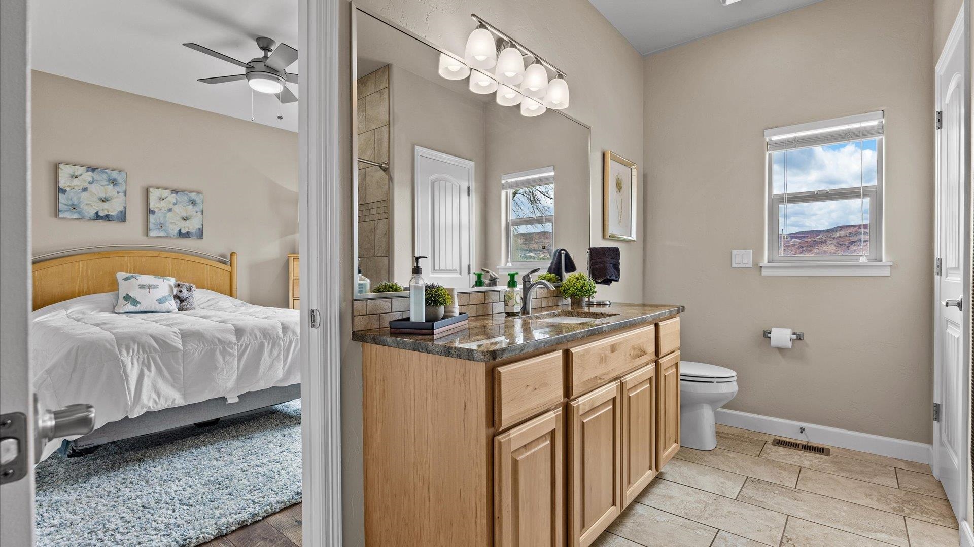 686 Beech Avenue Fruita, CO 81521 - Photo 23 of 33 a bath room with a bed and a chandelier