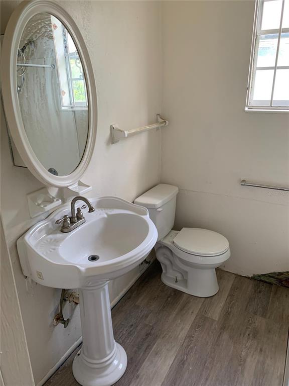 417 Maple Street Daytona Beach, FL 32114 - Photo 2 of 7 a bathroom with a toilet a sink and a mirror