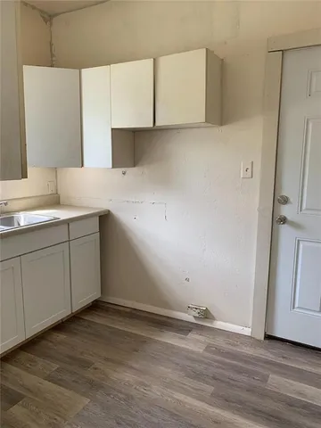 a view of cabinets and wooden floor