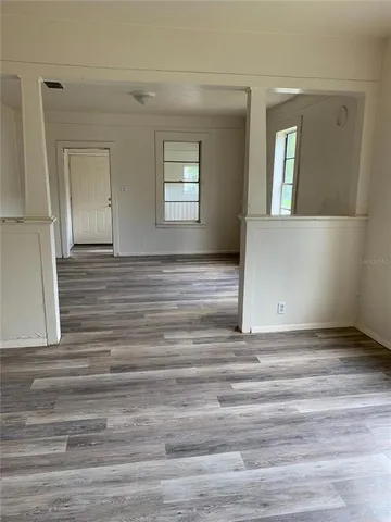 a view of wooden floor and windows in a room