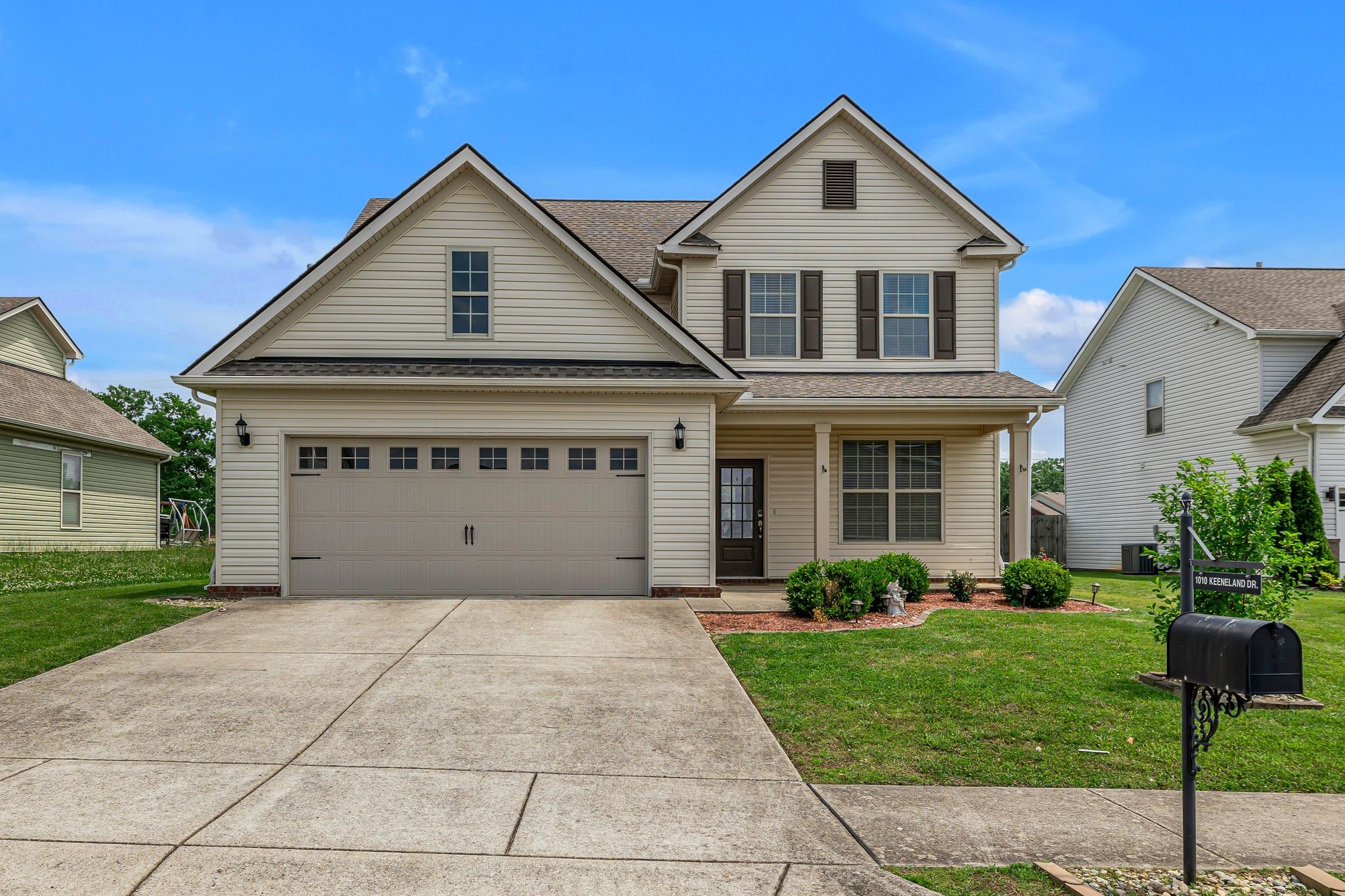 a front view of a house with a yard and garage