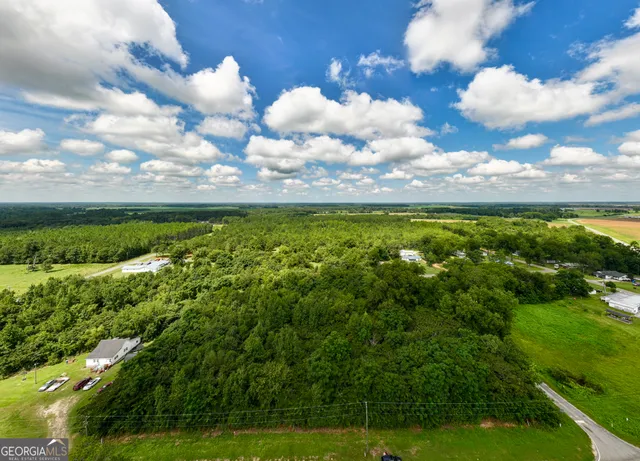a view of a big yard of grass and an aerial view of house