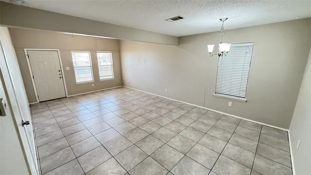 an empty room with windows and painted walls