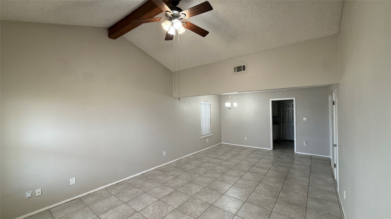 107 Owen Circle Georgetown, TX 78626 - Photo 3 of 13 an empty room with a chandelier fan and windows