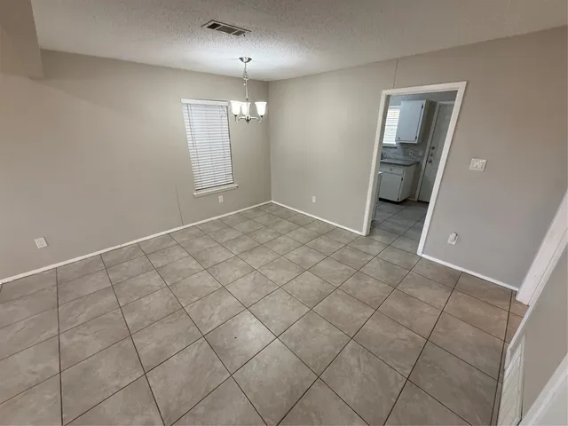 an empty room with staircase and white walls