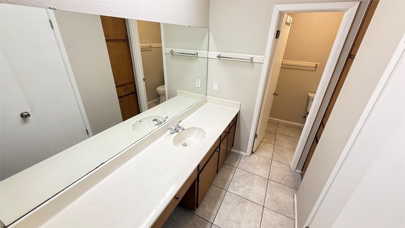 107 Owen Circle Georgetown, TX 78626 - Photo 8 of 13 a bathroom with a double vanity sink and a mirror