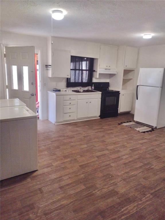 116 Edwards Street Bremen, GA 30110 - Photo 29 of 33 a large kitchen with cabinets and wooden floor