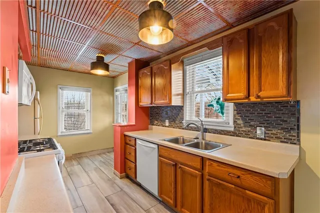 a kitchen that has a sink and a stove