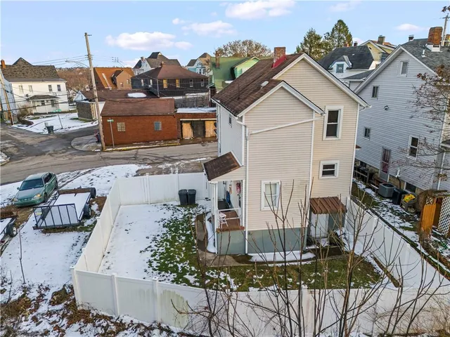 an aerial view of multiple houses with a yard