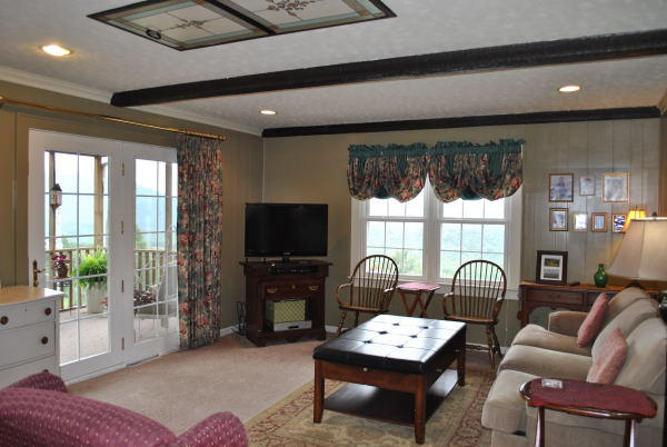 3467 Half Acre Of Rocks Road Elliston, VA 24087 - Photo 6 of 61 a living room with furniture a flat screen tv and a large window